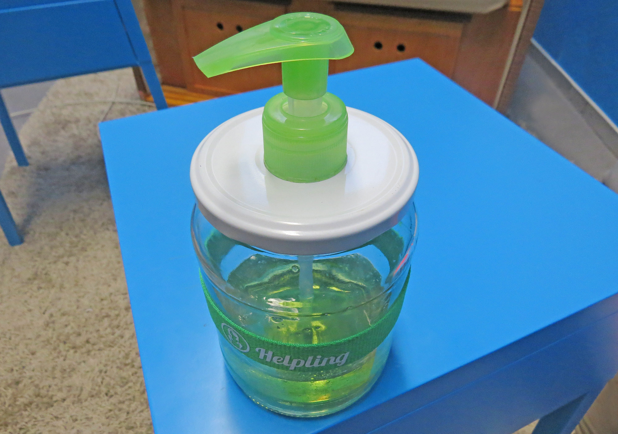 Upcycled Diy Soap Dispenser On Blue Table