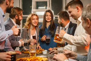 group friends enjoying evening drinks with beer wooden table