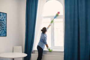 woman with sponge rubber gloves cleaning house