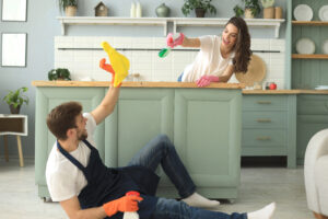 Young Happy Couple Is Having Fun While Doing Cleaning Home