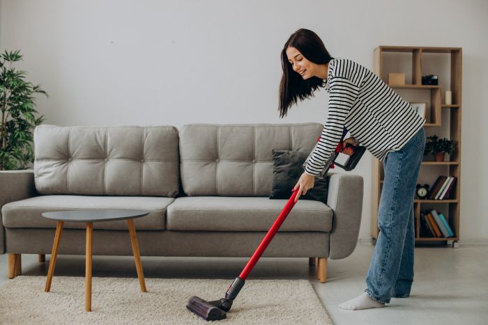 Woman Doing House Work With Rechargeable Vacuum Cleaner