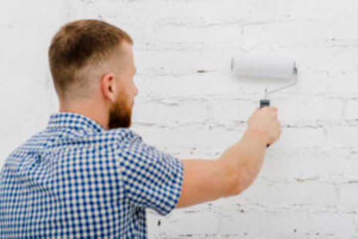 Back View Man Painting Wall With Roller 300X200 1