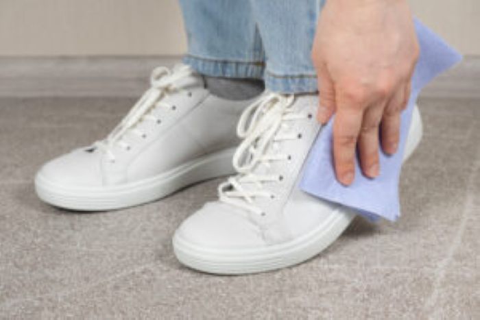 Cleaning White Shoes Caring Sneakers Woman Wipes Her Leather Shoes With Wet Cloth From Dust Dirt 300X200 1