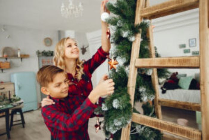 Family Standing Home Near Christmas Tree 300X200 1