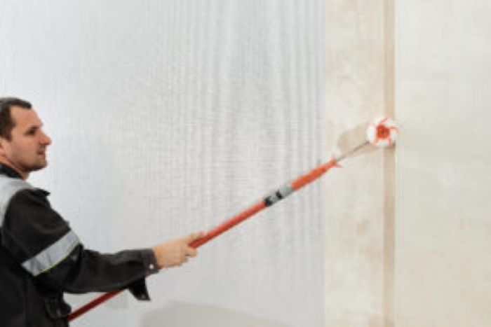 Man Worker Applies Glue With Paint Roller Walls Before Wallpapering Primer Walls Selective Focus Apartment Renovation Restoration Idea Indoors 300X200 1