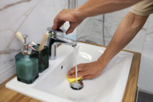 High Angle Man Cleaning Sink