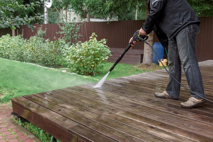 Man Cleaning Walls Floor With High Pressure Power Washer Washing Terrace Wood Planks