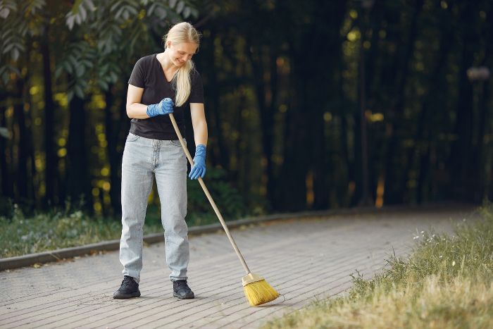 Woman Collects Leaves Cleans Park 1