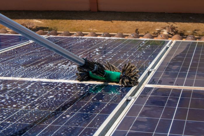 Solar Worker Cleaning Photovoltaic Panels With Brush Water Photovoltaic Cleaning