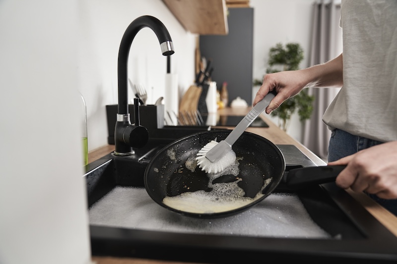 Close Up Caucasian Woman Washing Pans