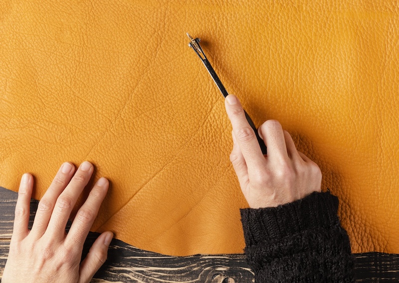 Close Up Hand Cutting Leather