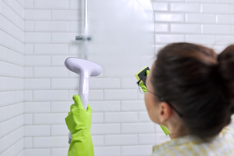 Woman Housewife Doing House Cleaning Bathroom Female Washing Glass With Shower Steam Using Steam Cleaner Quick Cleaning