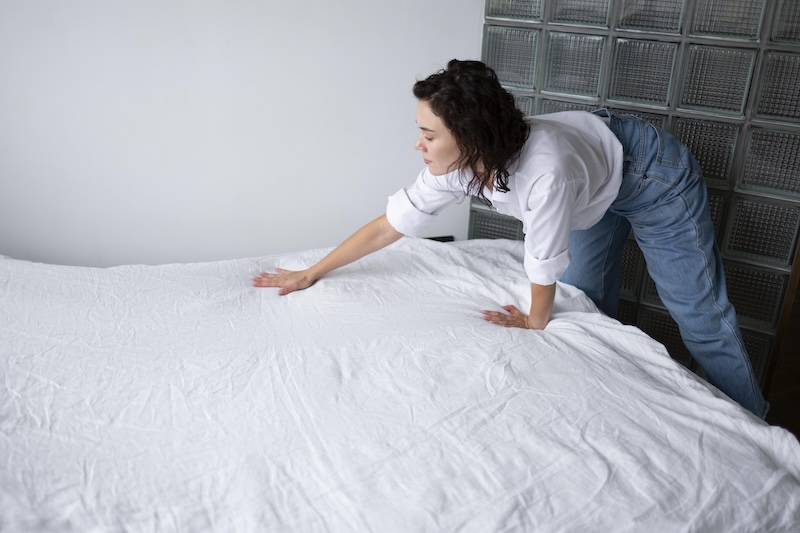 Medium Shot Woman Making Bed
