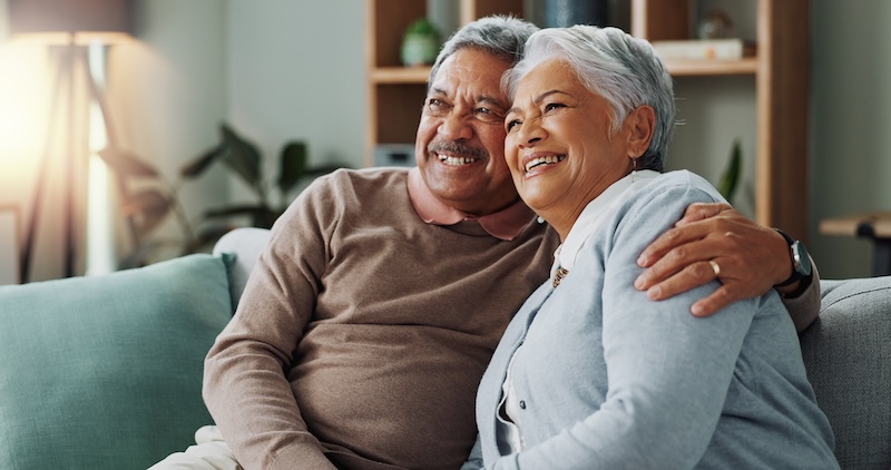 Senior Couple Relax Watching Tv Sofa With Hug Love Marriage Retirement Vacation Elderly People Together Couch Home With Trust Comfort Bonding With Happiness