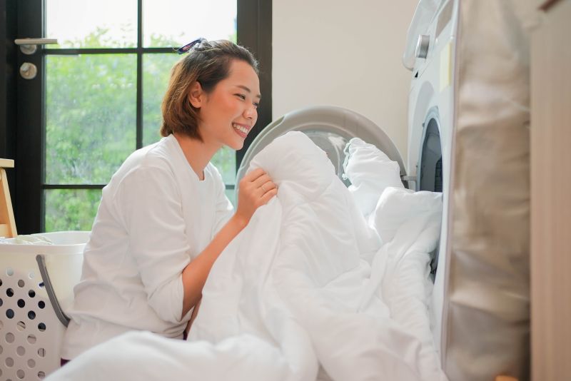 Asian Woman Pushing Blanket Washing Machine Start Cleaning Clothes Utility Room