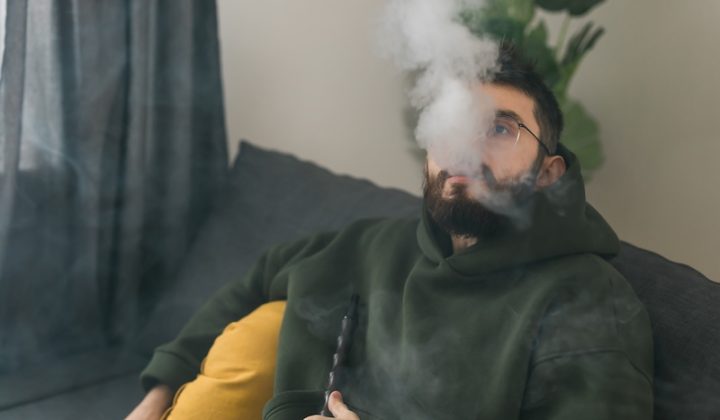 bearded man-smoking hookah while relaxing sofa home chill time resting