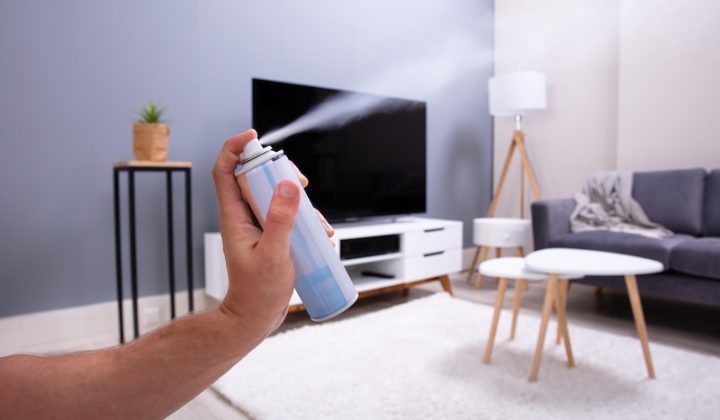 human hand spraying air freshener