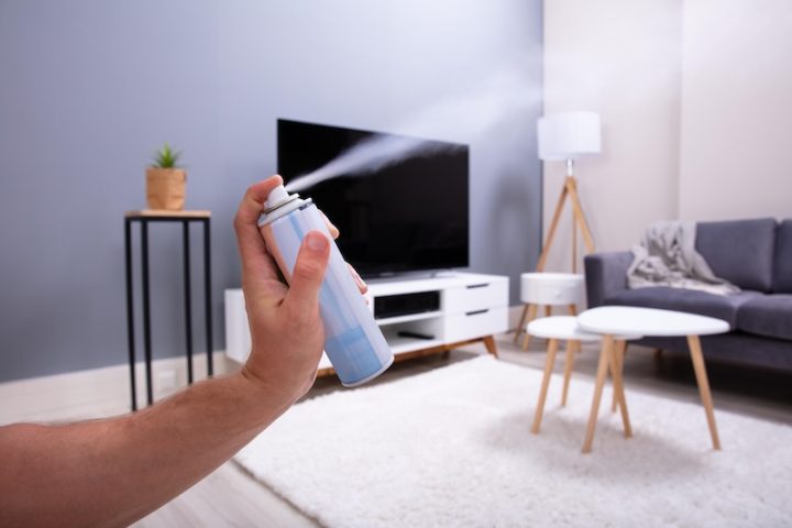 human hand spraying air freshener