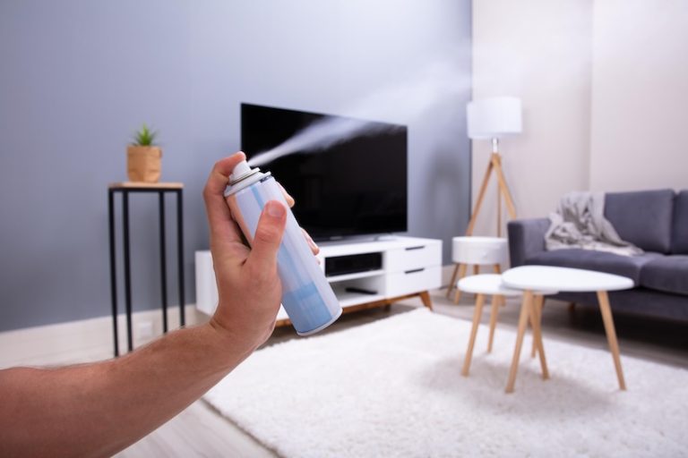 human hand spraying air freshener