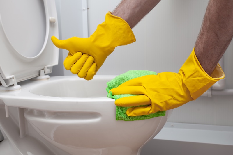 Male Hand Yellow Rubber Glove Showing Thumb Up Cleaning White Toilet Bowl