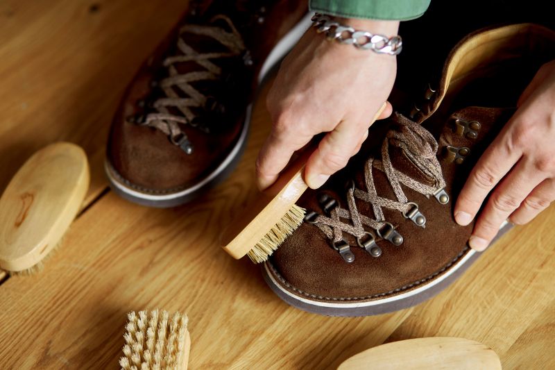 Man S Hand Cleans Suede Shoes With Brush 1