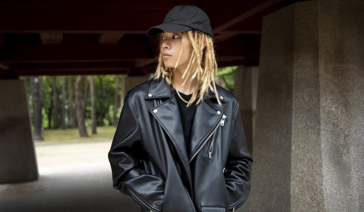 stylish person wearing a black cap, black t-shirt, and a black leather jacket
