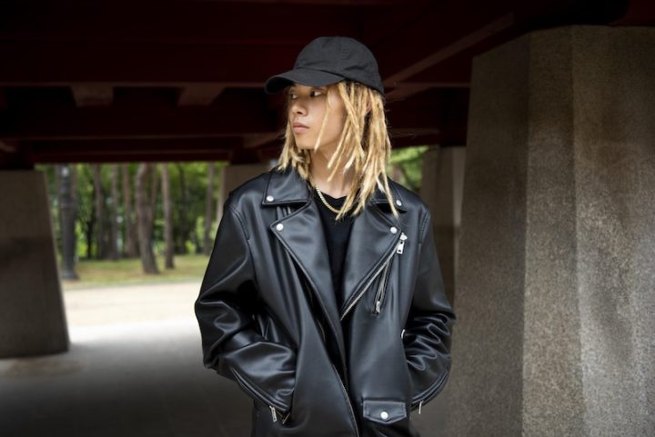 stylish person wearing a black cap, black t-shirt, and a black leather jacket