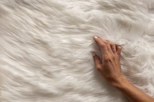 view hand going through textured fur fabric