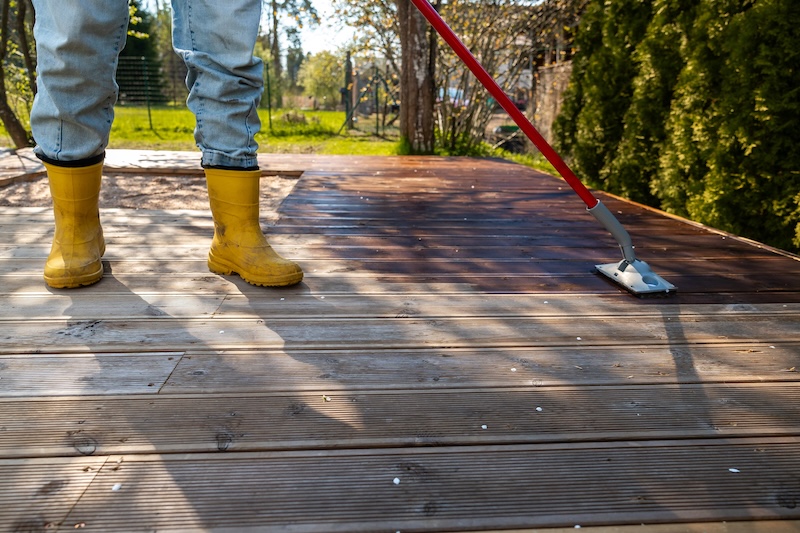 Applying Stain Wooden Deck With Brush Sunny Day