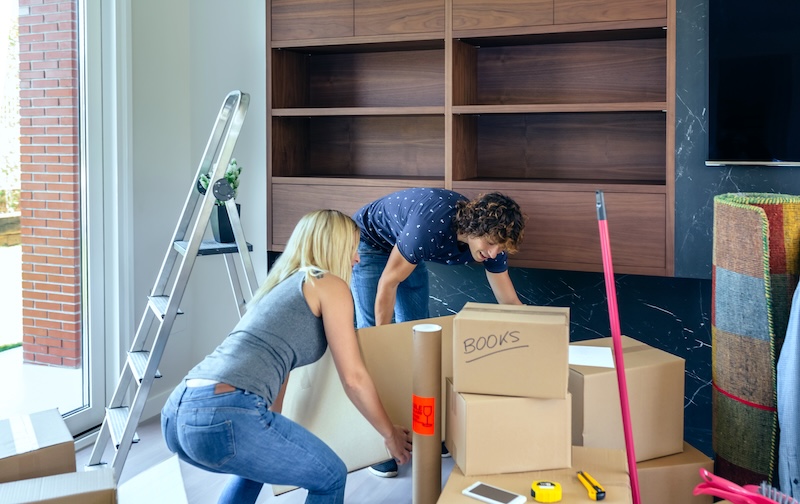 Couple Carrying Big Moving Box Their New Home