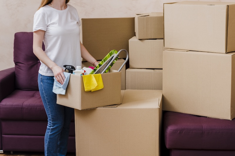 Crop Woman Packing Things Near Sofa