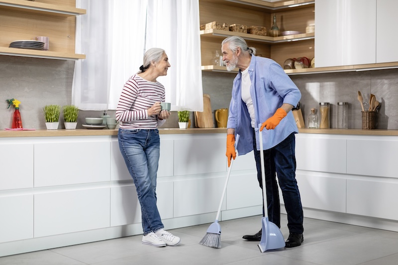 Portrait Happy Senior Spouses Making Cleaning Kitchen Together