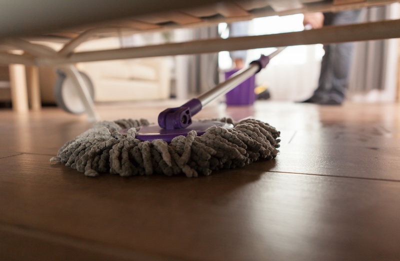 Guy Mopping Dust Sofa Apartment