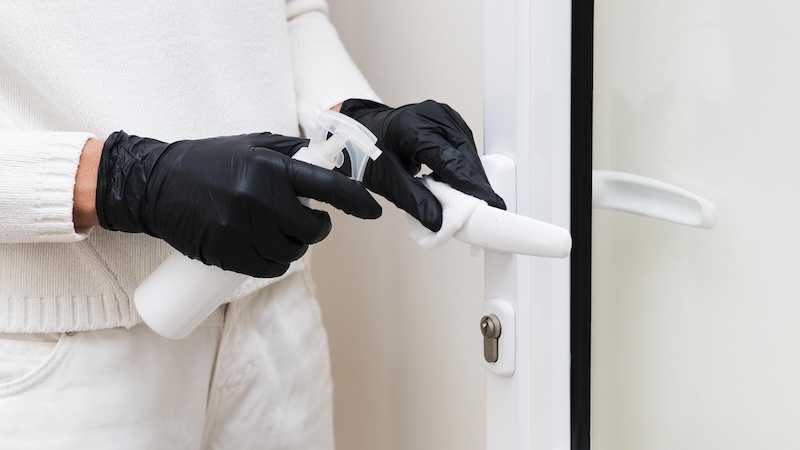Hands With Gloves Disinfecting Door Handle