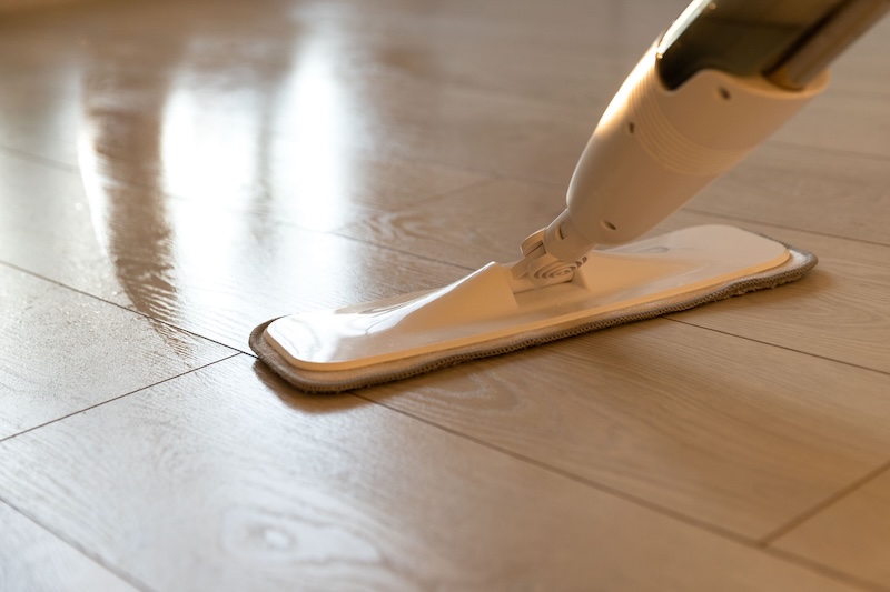 Person Using Spray Mop Pad Refillable Bottle With Cleaning Solution Mopping Floor Apartment